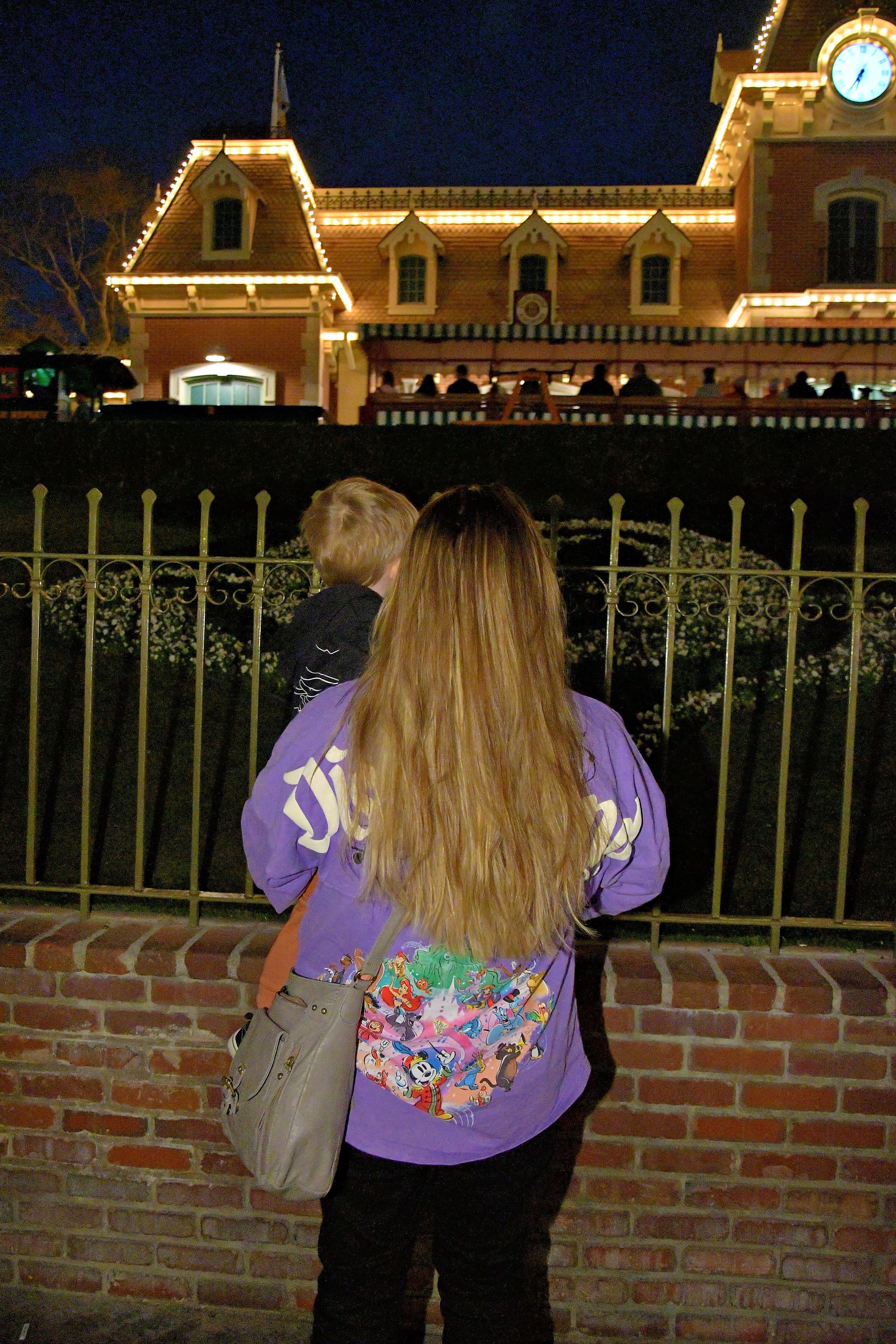 Madison and her son looking out at Disneyland